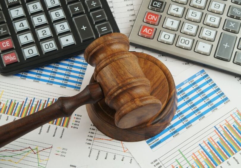 calculator and gavel representing legal compensation