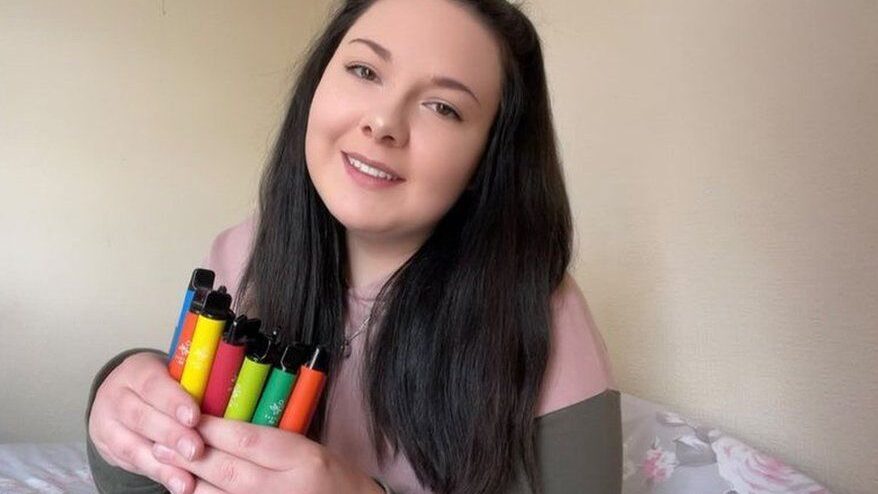 child holding a non nicotine vape product