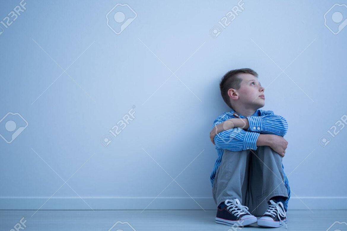 child sitting alone in an empty room