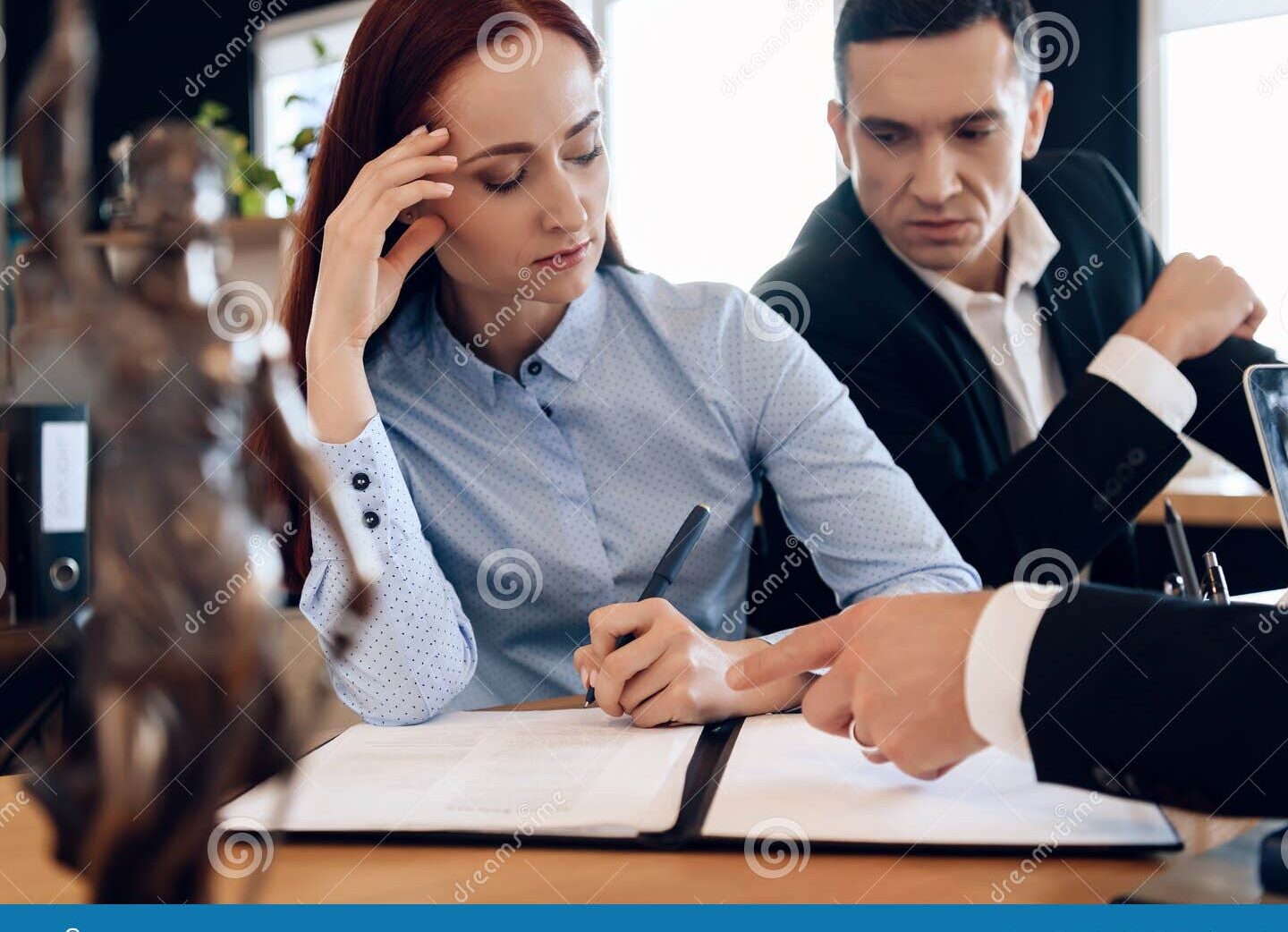 divorced couple signing divorce papers