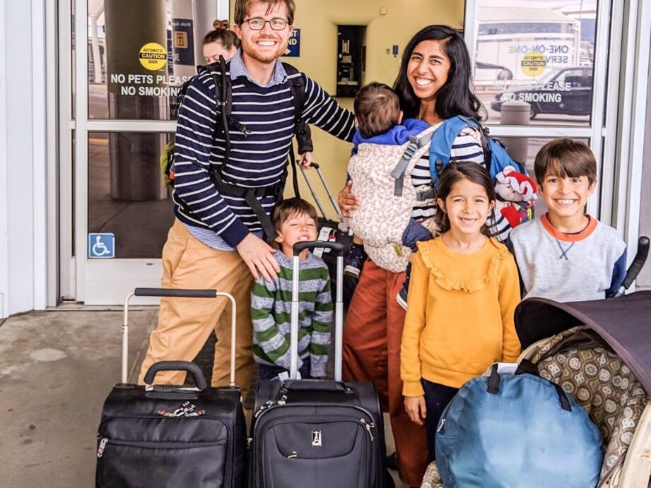 family traveling with suitcase and passport