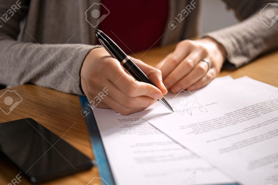 hand holding a signed legal document