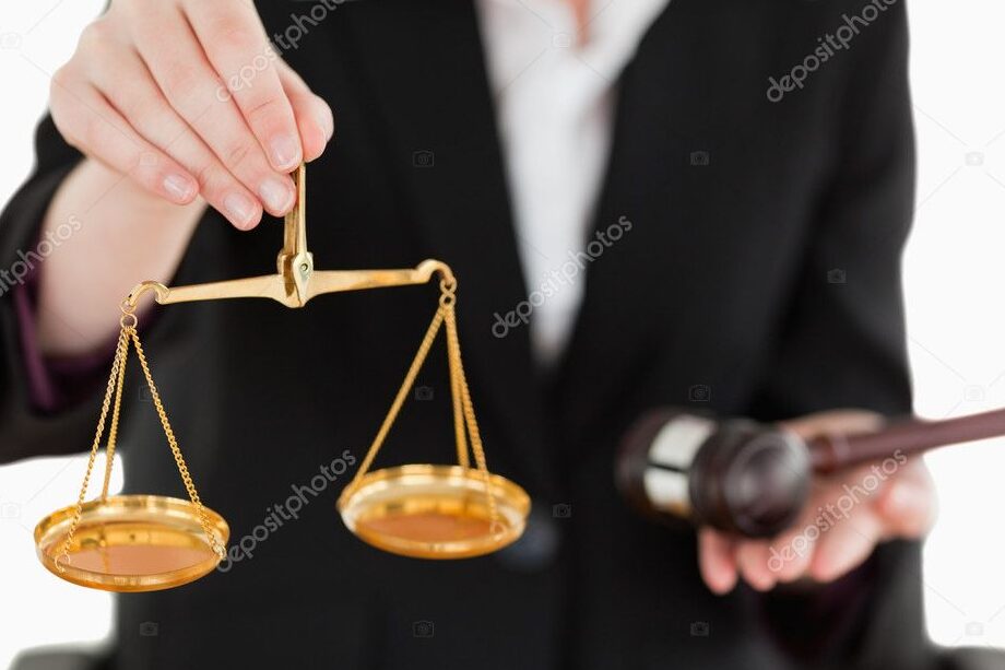 hand holding gavel and scales of justice 1