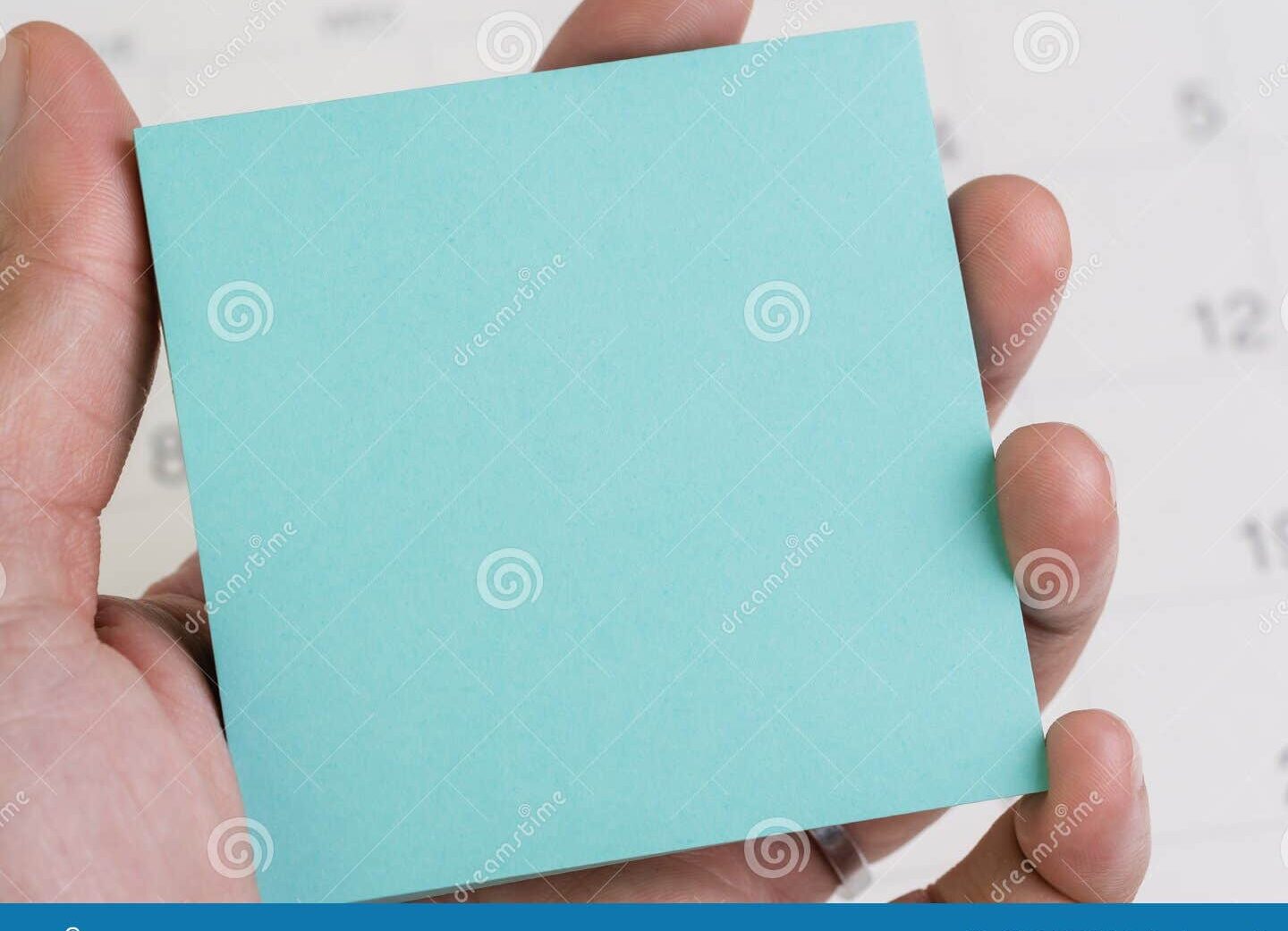 image hand holding a calendar with vacation days circled