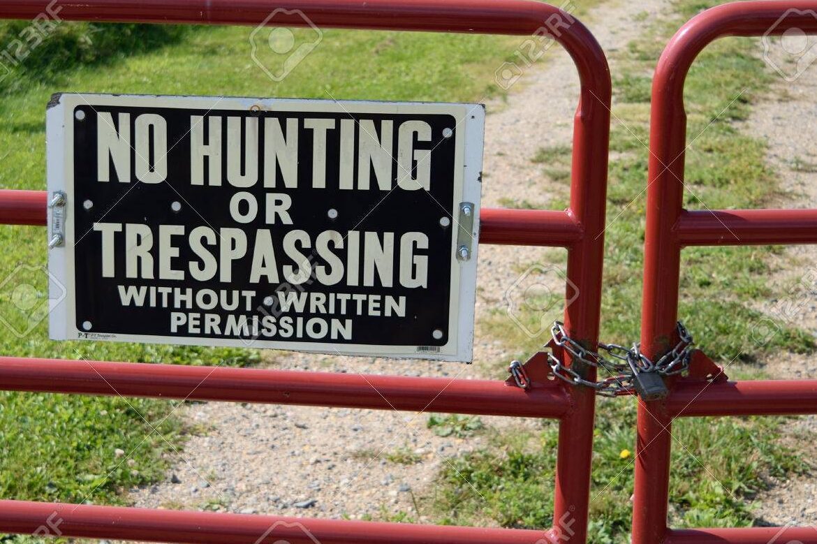 no trespassing sign with a locked gate