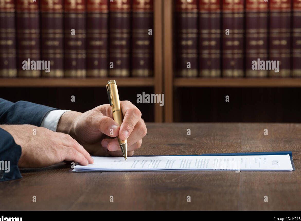 person filling out legal documents at a courthouse